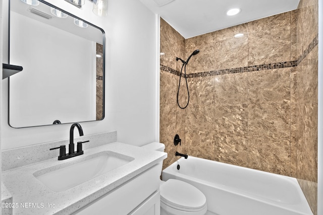 full bathroom featuring vanity, bathtub / shower combination, and toilet