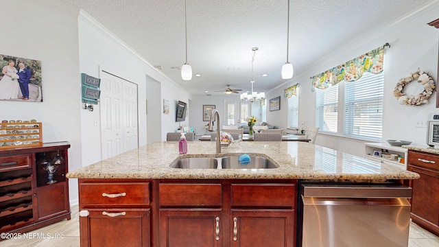 kitchen featuring dishwasher, ornamental molding, a kitchen island with sink, a textured ceiling, and a sink