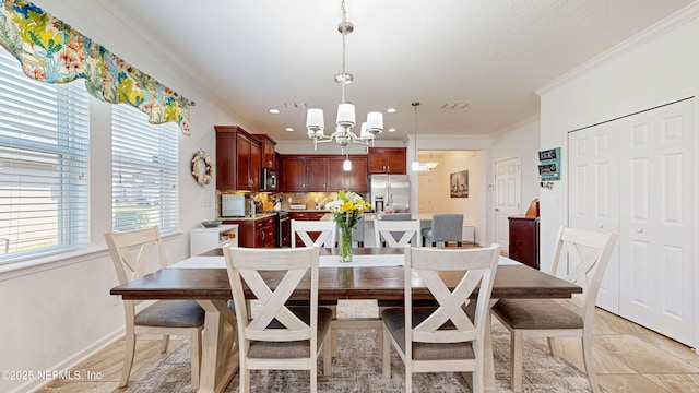 dining area featuring ornamental molding, a chandelier, and baseboards