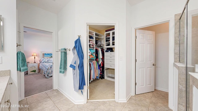 spacious closet featuring light carpet and light tile patterned flooring