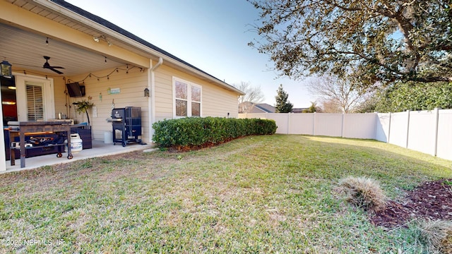 view of yard with a patio area, a fenced backyard, and a ceiling fan