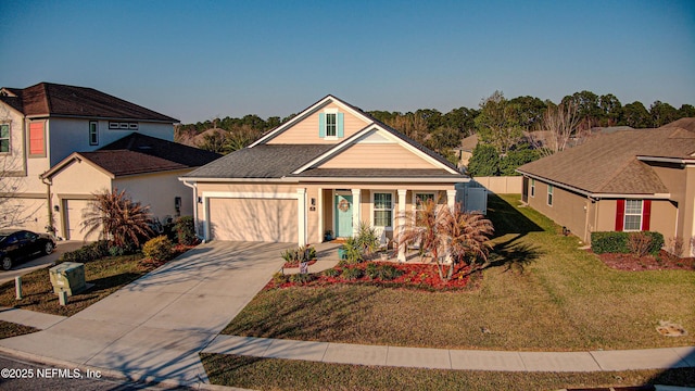 view of front of house with an attached garage, concrete driveway, and a front yard