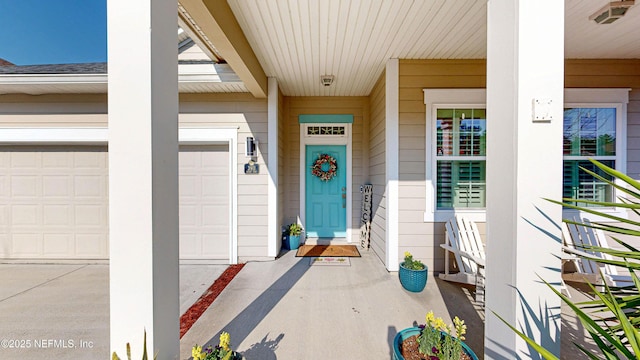 property entrance featuring a garage and driveway