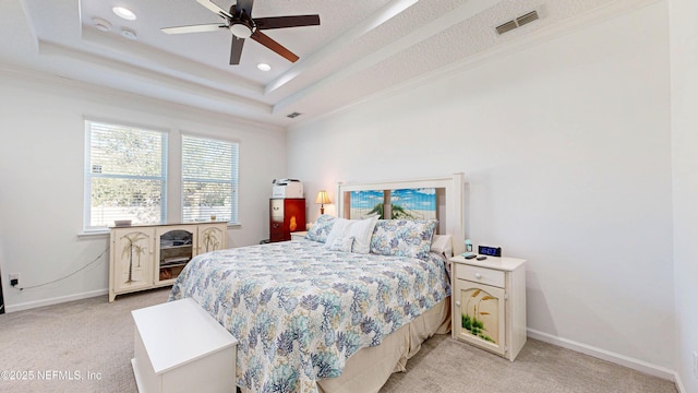 bedroom featuring a tray ceiling, recessed lighting, light colored carpet, visible vents, and baseboards