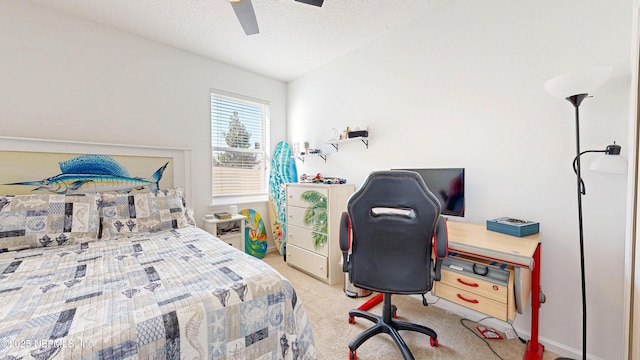 carpeted bedroom featuring ceiling fan and a textured ceiling