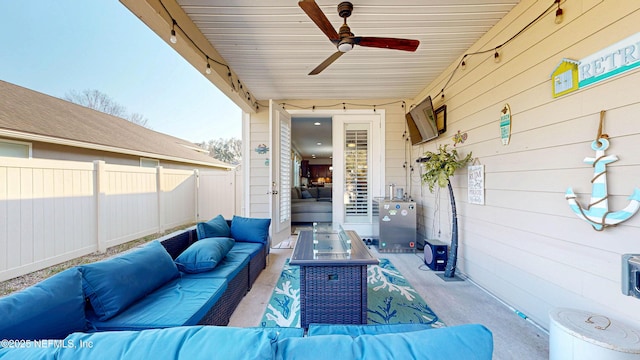 view of patio with ceiling fan, fence, and an outdoor living space