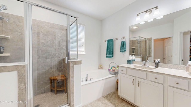 full bathroom with a stall shower, vanity, a garden tub, and tile patterned floors