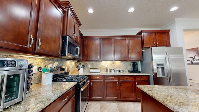 kitchen with a textured ceiling, light stone counters, ornamental molding, appliances with stainless steel finishes, and decorative backsplash