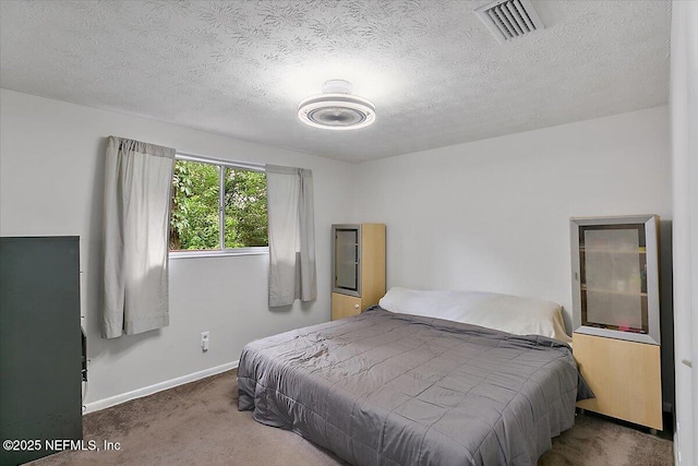 carpeted bedroom with a textured ceiling