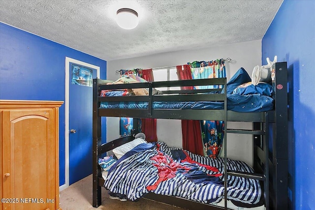 carpeted bedroom featuring a textured ceiling