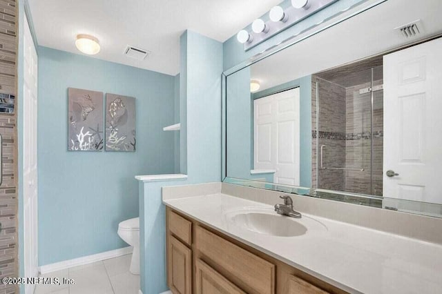 bathroom with tile patterned flooring, vanity, a shower with door, and toilet