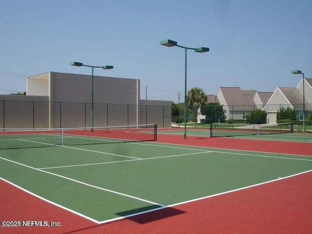 view of tennis court featuring basketball court