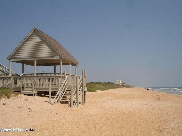 view of property's community with a beach view and a water view