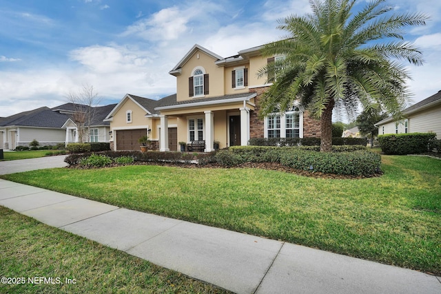 view of front of property featuring a front lawn and a garage