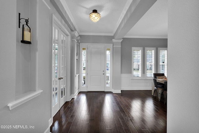 entryway featuring crown molding, dark hardwood / wood-style flooring, and decorative columns