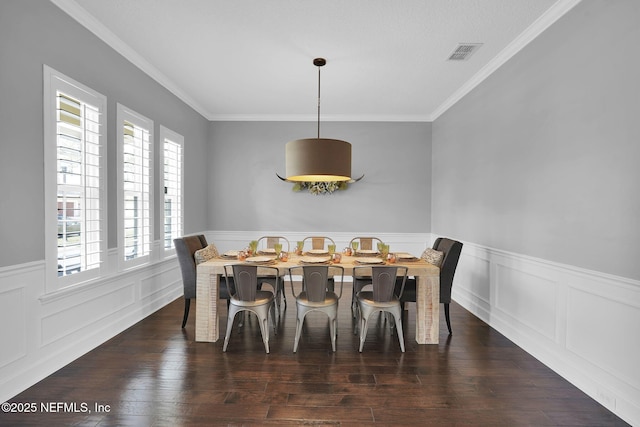 dining room with dark hardwood / wood-style flooring and ornamental molding