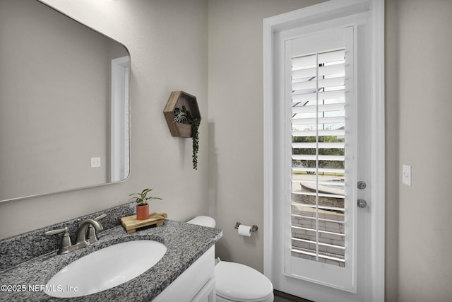 bathroom featuring vanity and toilet