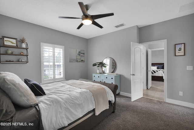 carpeted bedroom with a textured ceiling and ceiling fan