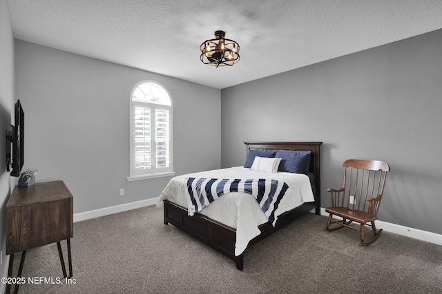 bedroom featuring a textured ceiling and carpet flooring