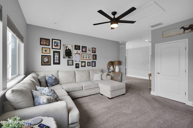 living room featuring carpet, ornate columns, and ceiling fan