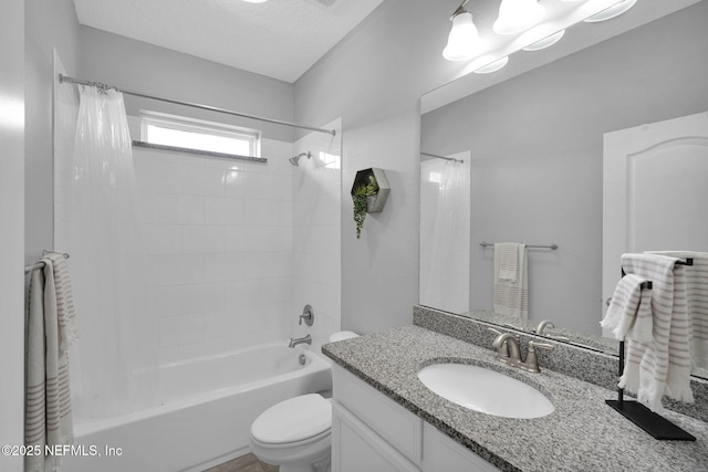 full bathroom with a textured ceiling, shower / bath combo with shower curtain, vanity, and toilet