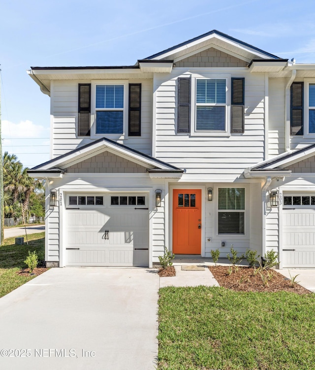 view of front facade with a garage and a front lawn