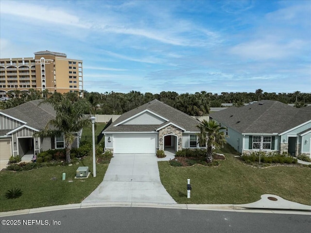 single story home featuring a garage, stone siding, concrete driveway, and a front yard