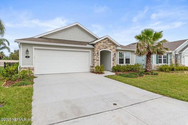 ranch-style home with a garage, driveway, stone siding, and a front yard