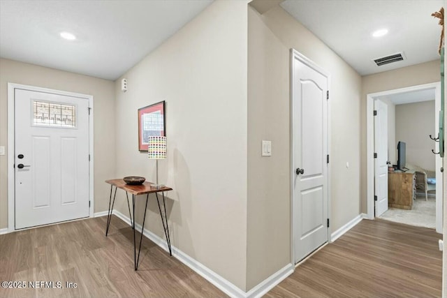 entrance foyer featuring baseboards, visible vents, wood finished floors, and recessed lighting