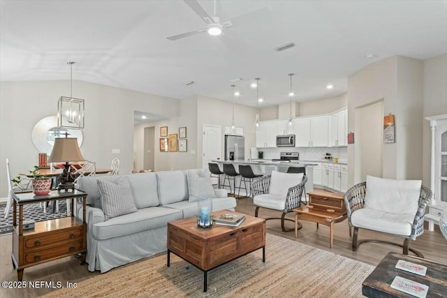 living room featuring recessed lighting, visible vents, ceiling fan, and light wood-style flooring