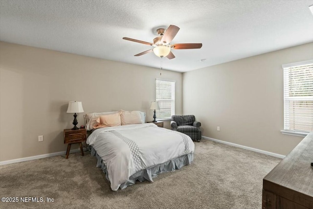 bedroom featuring carpet flooring, a textured ceiling, baseboards, and multiple windows