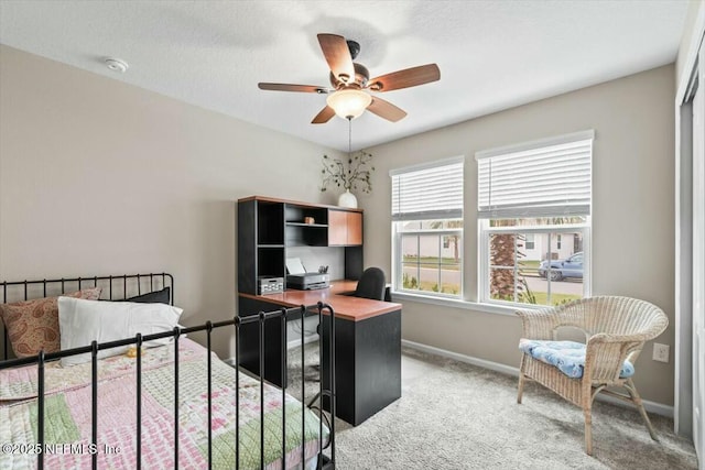 bedroom with a ceiling fan, light colored carpet, and baseboards