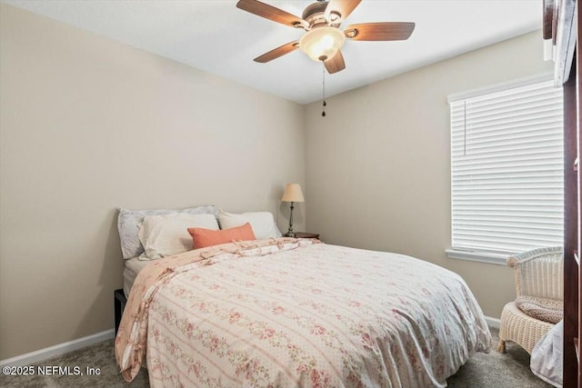 carpeted bedroom with a ceiling fan and baseboards