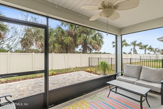 unfurnished sunroom featuring a wealth of natural light and ceiling fan