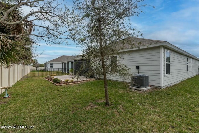 back of property featuring central AC, a lawn, a patio area, and a fenced backyard