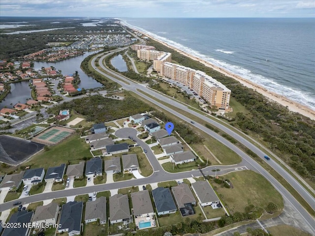 aerial view featuring a water view, a residential view, and a view of the beach