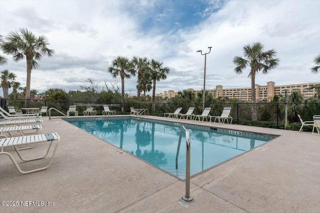 community pool featuring a patio area and fence