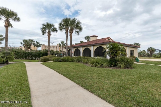 view of community featuring a garage and a lawn