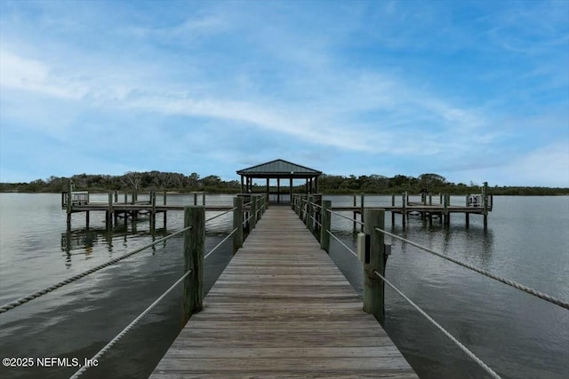 view of dock featuring a gazebo and a water view