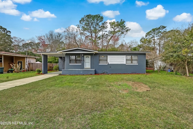 ranch-style home featuring a carport and a front lawn