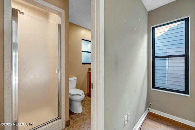 bathroom with vanity, toilet, a textured ceiling, and walk in shower