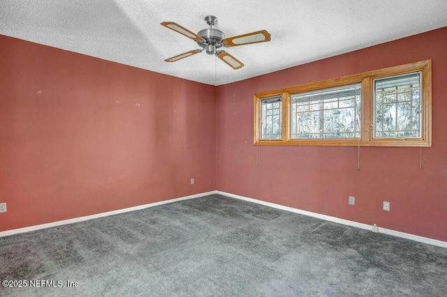 spare room featuring ceiling fan, carpet flooring, and a textured ceiling