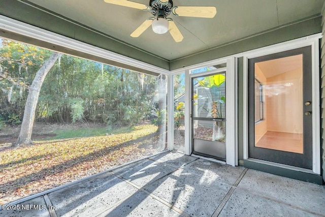 unfurnished sunroom featuring a wealth of natural light and ceiling fan