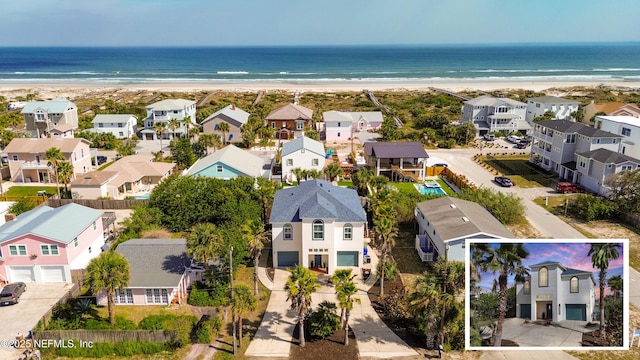 drone / aerial view with a view of the beach, a residential view, and a water view