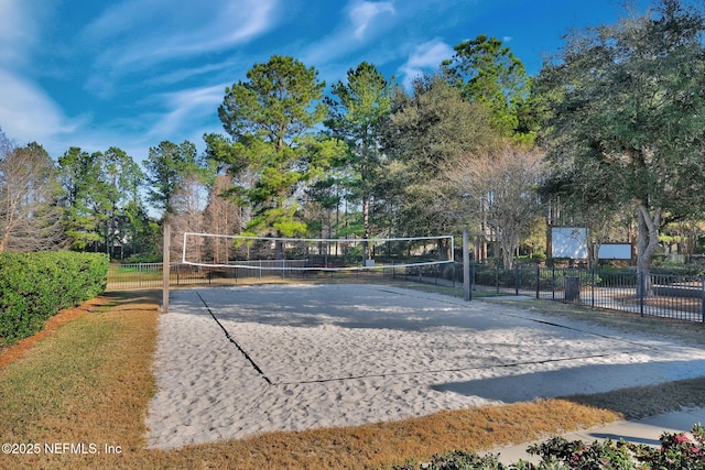 view of community with fence and volleyball court