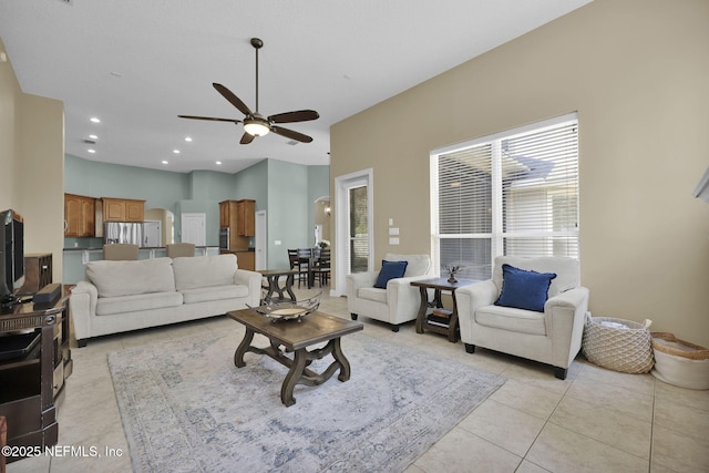 living room featuring light tile patterned floors, ceiling fan, and recessed lighting