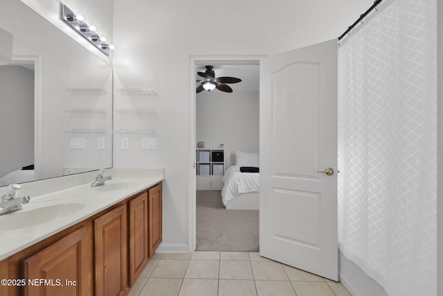 full bath with double vanity, tile patterned flooring, a sink, and ensuite bathroom