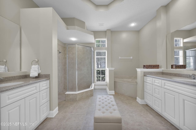 full bath with a stall shower, tile patterned flooring, a sink, and a bath