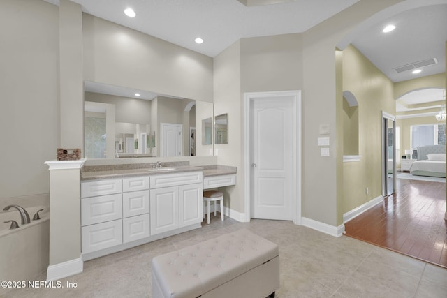 bathroom featuring baseboards, visible vents, tile patterned flooring, vanity, and recessed lighting