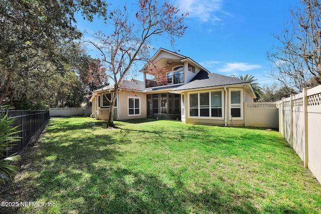 rear view of property featuring a balcony, a yard, a fenced backyard, and a sunroom